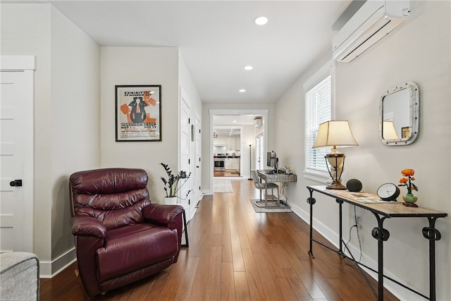914 James St, East Allegheny, PA 15212 - sitting room with a wall mounted air conditioner, recessed lighting, wood finished floors, and baseboards