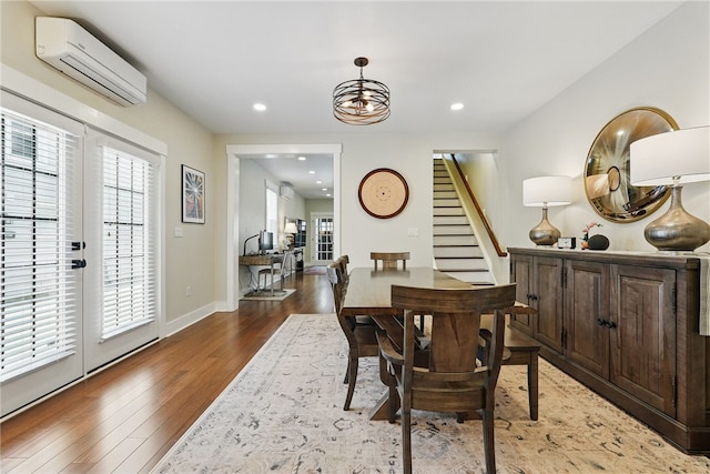 914 James St, East Allegheny, PA 15212 - dining space featuring a wall mounted AC, stairs, wood finished floors, a chandelier, and recessed lighting