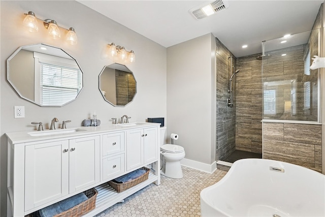 914 James St, East Allegheny, PA 15212 - full bath featuring double vanity, tiled shower, a freestanding bath, toilet, and tile patterned floors
