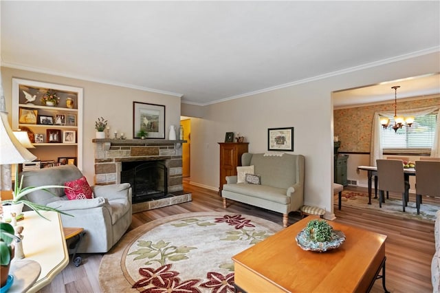 407 Neola Cir, Ross Twp, PA 15237 - living area featuring a chandelier, wood finished floors, ornamental molding, a stone fireplace, and baseboards