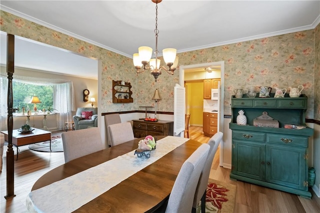 407 Neola Cir, Ross Twp, PA 15237 - dining area featuring wallpapered walls, a chandelier, light wood-type flooring, and crown molding