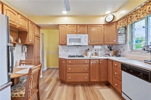 407 Neola Cir, Ross Twp, PA 15237 - kitchen featuring white appliances, light wood-style flooring, decorative backsplash, and light countertops