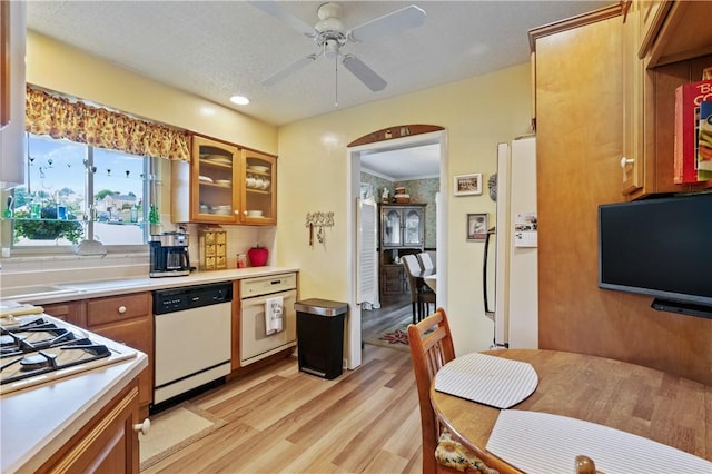 407 Neola Cir, Ross Twp, PA 15237 - kitchen featuring white appliances, light countertops, light wood-type flooring, brown cabinetry, and glass insert cabinets