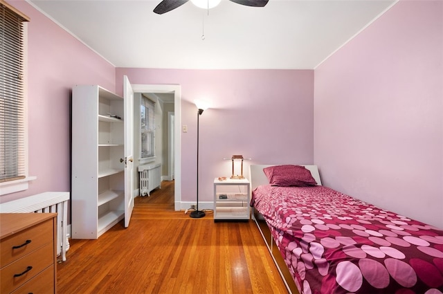 2323 Tilbury Ave, Squirrel Hill, PA 15217 - bedroom with radiator, wood finished floors, a ceiling fan, baseboards, and crown molding