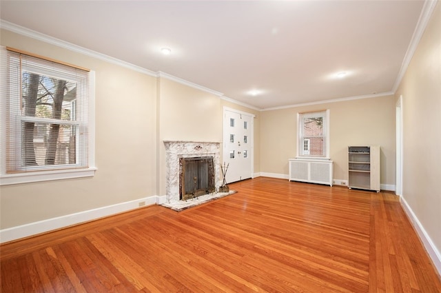 2323 Tilbury Ave, Squirrel Hill, PA 15217 - unfurnished living room featuring radiator, light wood finished floors, baseboards, a high end fireplace, and crown molding