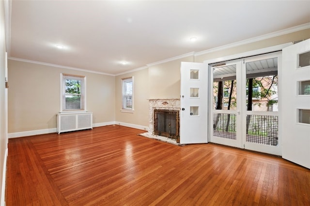 2323 Tilbury Ave, Squirrel Hill, PA 15217 - unfurnished living room featuring radiator, wood finished floors, a high end fireplace, ornamental molding, and baseboards