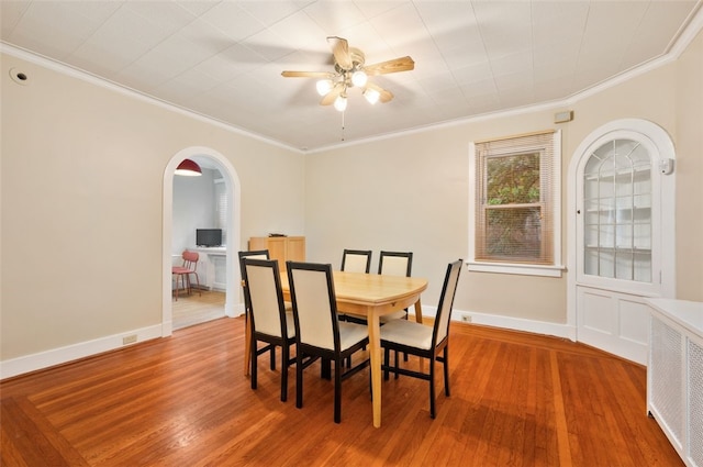 2323 Tilbury Ave, Squirrel Hill, PA 15217 - dining room featuring arched walkways, crown molding, ceiling fan, wood finished floors, and baseboards