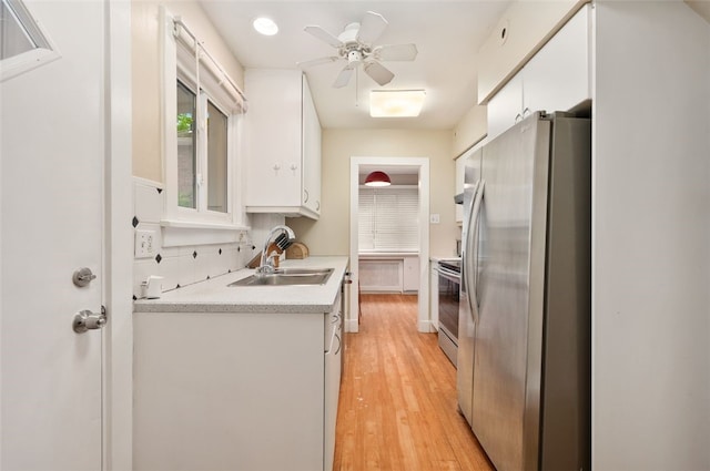 2323 Tilbury Ave, Squirrel Hill, PA 15217 - kitchen with appliances with stainless steel finishes, a sink, white cabinetry, light countertops, and light wood finished floors