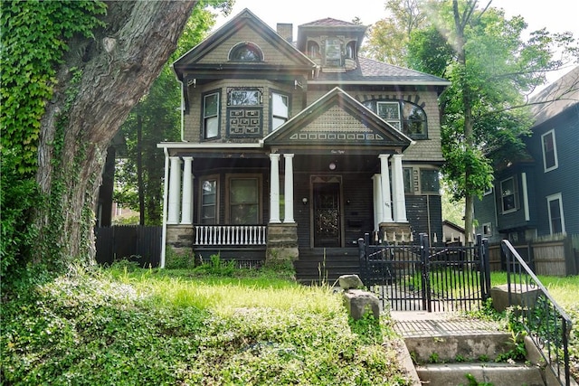 150 Euclid Ave, Sharon, PA 16146 - victorian home with a porch, a fenced front yard, and a gate