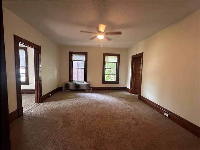 150 Euclid Ave, Sharon, PA 16146 - carpeted empty room featuring radiator and ceiling fan