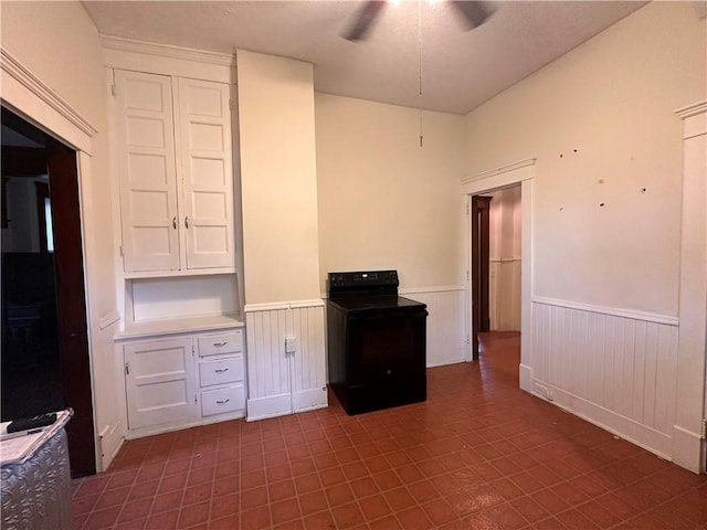 150 Euclid Ave, Sharon, PA 16146 - kitchen with black electric range, wainscoting, ceiling fan, white cabinets, and light countertops