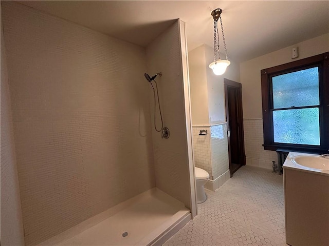 150 Euclid Ave, Sharon, PA 16146 - bathroom with a tile shower, vanity, tile patterned flooring, a wainscoted wall, and tile walls