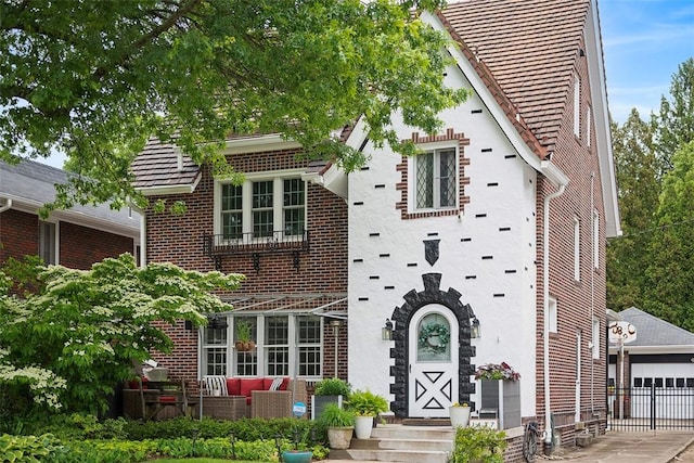 1437 Browning Rd, Highland Park, PA 15206 - view of front of property with brick siding, outdoor lounge area, and a detached garage