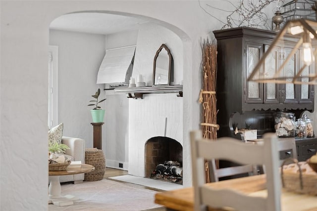 1437 Browning Rd, Highland Park, PA 15206 - tiled living room featuring arched walkways and a fireplace with flush hearth