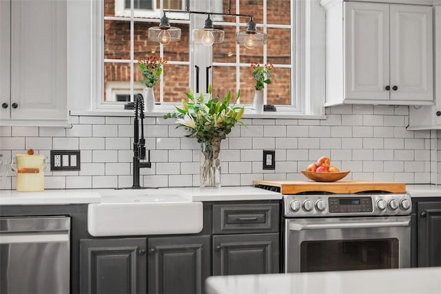 1437 Browning Rd, Highland Park, PA 15206 - kitchen featuring appliances with stainless steel finishes, a sink, light countertops, backsplash, and white cabinets