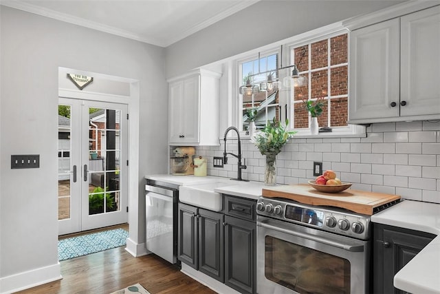 1437 Browning Rd, Highland Park, PA 15206 - kitchen featuring appliances with stainless steel finishes, a sink, wood finished floors, french doors, and light countertops