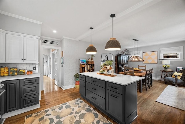 1437 Browning Rd, Highland Park, PA 15206 - kitchen with baseboards, white cabinetry, light countertops, wood finished floors, and crown molding