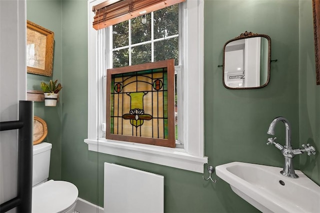 1437 Browning Rd, Highland Park, PA 15206 - half bathroom featuring a sink, toilet, and baseboards
