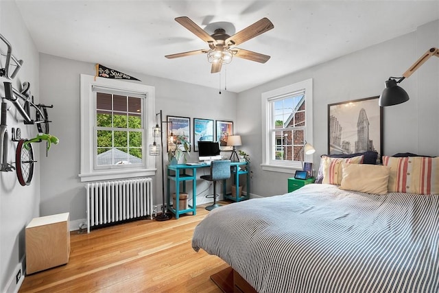 1437 Browning Rd, Highland Park, PA 15206 - bedroom featuring radiator, wood finished floors, baseboards, ceiling fan, and a desk