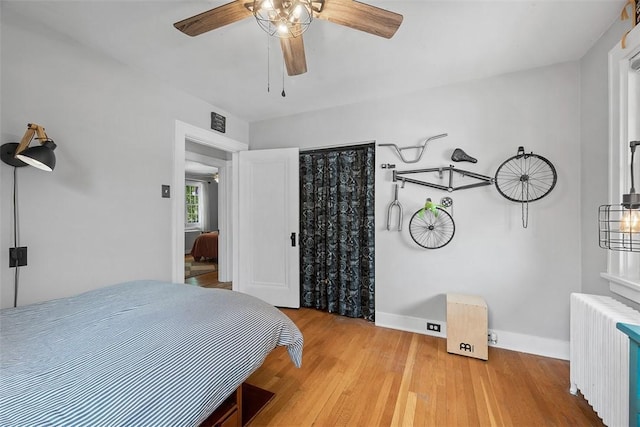 1437 Browning Rd, Highland Park, PA 15206 - bedroom featuring radiator heating unit, wood finished floors, baseboards, and a ceiling fan