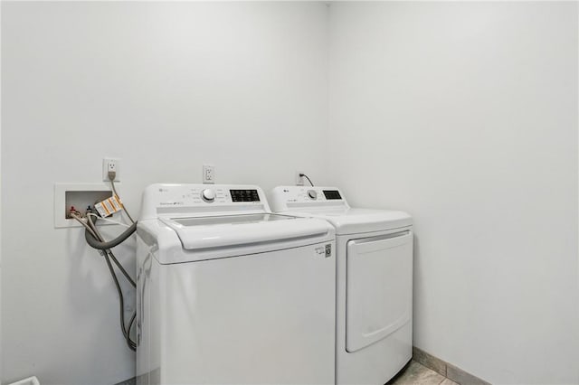 5523 Butler St, Lawrenceville, PA 15201 - laundry area featuring independent washer and dryer and light tile patterned floors