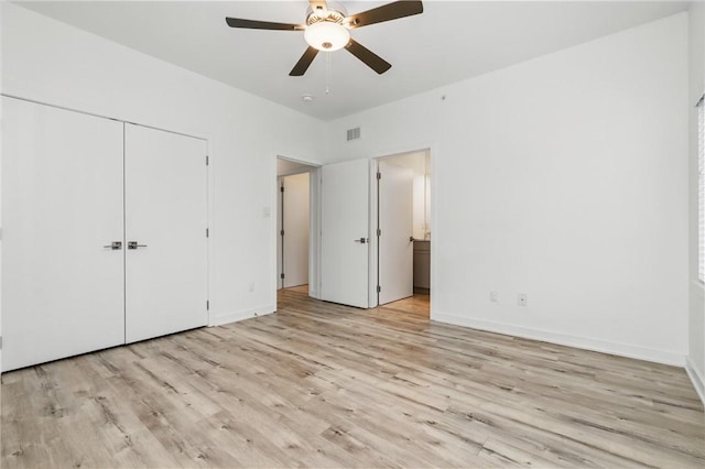 5523 Butler St, Lawrenceville, PA 15201 - unfurnished bedroom with light wood-type flooring, a closet, and baseboards