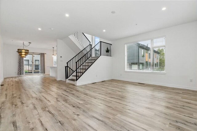 5523 Butler St, Lawrenceville, PA 15201 - unfurnished living room with plenty of natural light, light wood-style flooring, baseboards, and recessed lighting