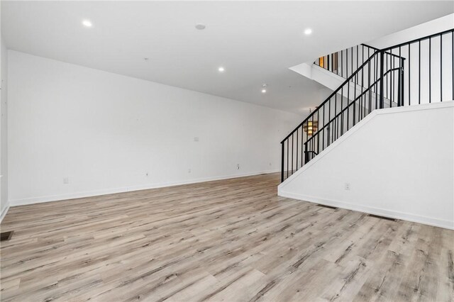 5523 Butler St, Lawrenceville, PA 15201 - unfurnished living room with stairway, light wood-style floors, recessed lighting, and baseboards