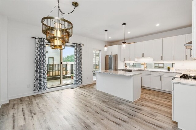 5523 Butler St, Lawrenceville, PA 15201 - kitchen featuring high end refrigerator, a sink, a center island, a chandelier, and light wood finished floors