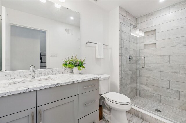 5523 Butler St, Lawrenceville, PA 15201 - full bathroom featuring vanity, a stall shower, toilet, and recessed lighting