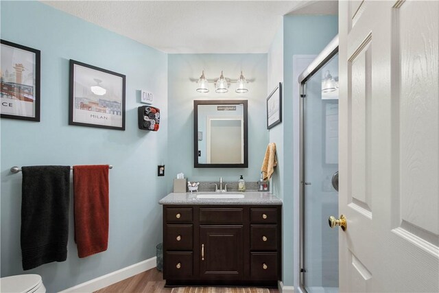 5743 Villahaven Dr, Bethel Park, PA 15236 - full bath featuring vanity, wood finished floors, a shower stall, toilet, and baseboards