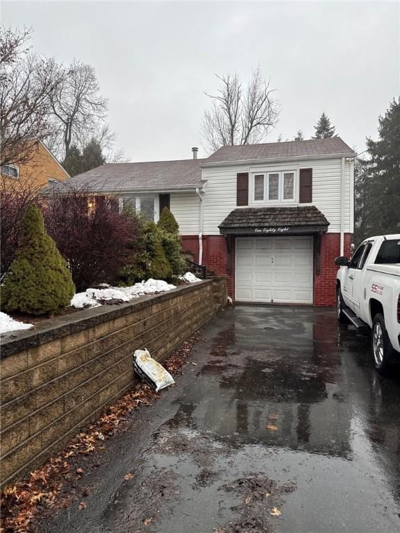 188 Chickasaw Ave, Mccandless, PA 15237 - view of front facade featuring driveway, brick siding, and a garage