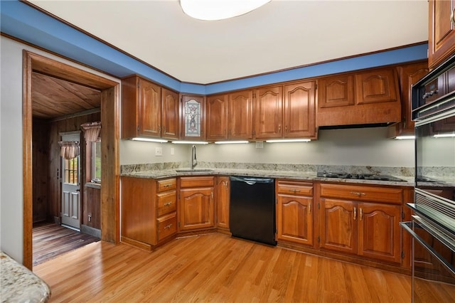 2525 Chapelwood Dr, Upper St Clair, PA 15241 - kitchen with black appliances, a sink, brown cabinets, light wood-style flooring, and light stone countertops
