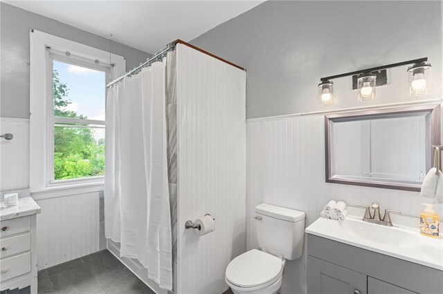 1222 Forest Ave, New Kensington, PA 15068 - bathroom with vanity, wainscoting, toilet, and a shower with curtain