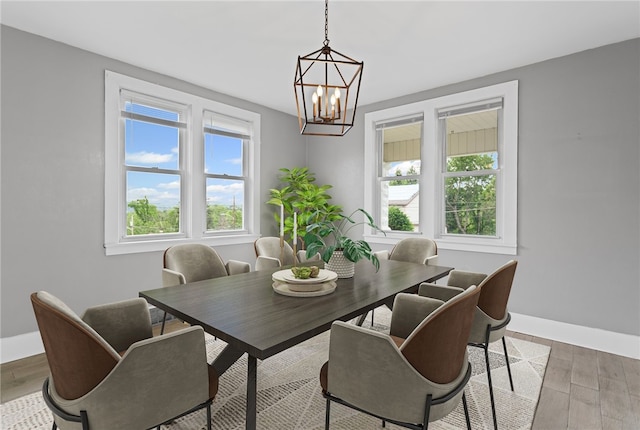 1222 Forest Ave, New Kensington, PA 15068 - dining room with plenty of natural light, baseboards, a chandelier, and light wood-style floors