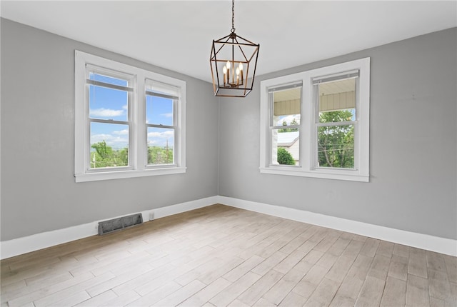 1222 Forest Ave, New Kensington, PA 15068 - unfurnished room featuring plenty of natural light, a chandelier, and baseboards