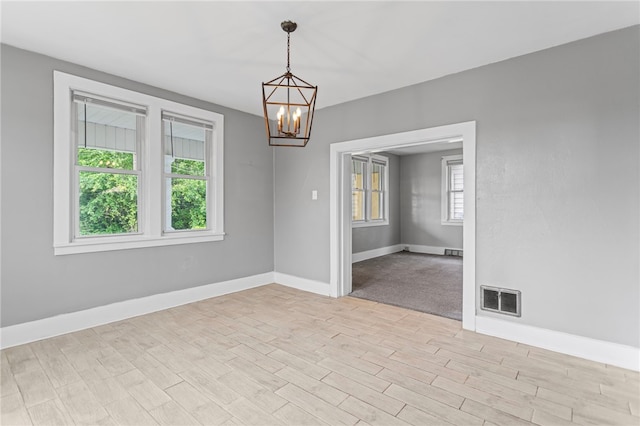 1222 Forest Ave, New Kensington, PA 15068 - spare room with a chandelier, baseboards, and light wood-type flooring