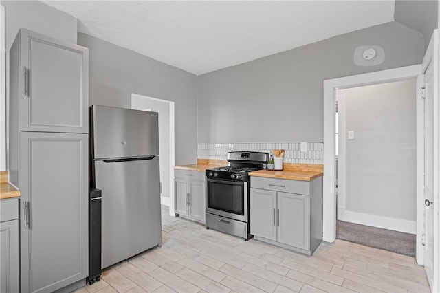 1222 Forest Ave, New Kensington, PA 15068 - kitchen featuring stainless steel appliances, butcher block counters, gray cabinetry, and light wood-type flooring