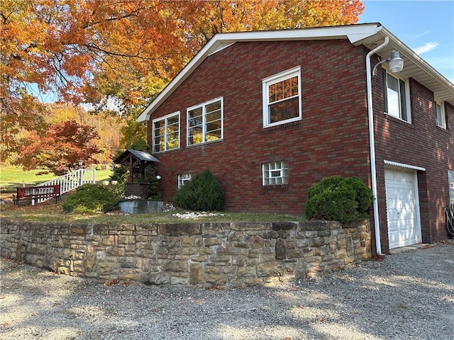 1877 Main St, Arona, PA 15617 - view of side of home with an attached garage and brick siding