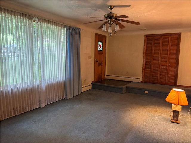 1877 Main St, Arona, PA 15617 - unfurnished living room featuring baseboard heating, ceiling fan, and carpet floors