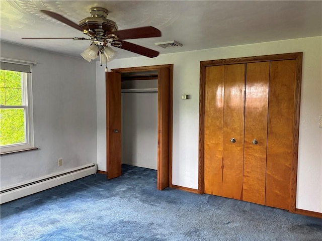 1877 Main St, Arona, PA 15617 - unfurnished bedroom with carpet flooring, baseboard heating, two closets, a ceiling fan, and baseboards