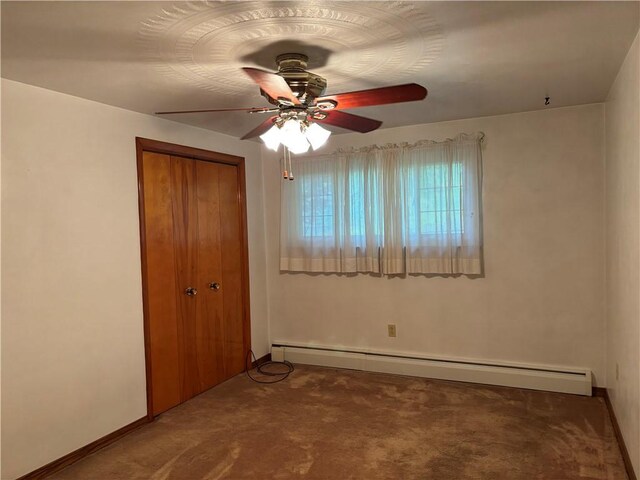 1877 Main St, Arona, PA 15617 - unfurnished bedroom featuring a baseboard heating unit, carpet flooring, a closet, and baseboards