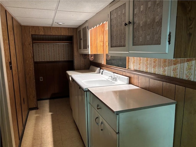 1877 Main St, Arona, PA 15617 - kitchen with wallpapered walls, wood walls, light floors, a wainscoted wall, and light countertops