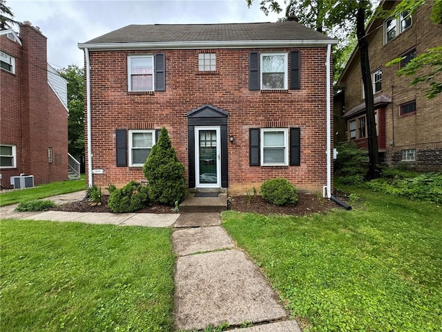 1022-1024 S Trenton Ave, Regent Square, PA 15221 - view of front facade with brick siding, a front lawn, central AC, and roof with shingles