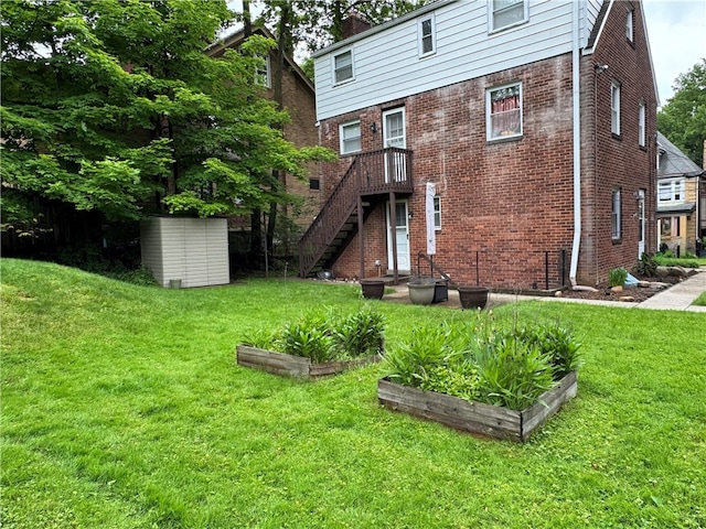 1022-1024 S Trenton Ave, Regent Square, PA 15221 - rear view of property with a garden, a yard, and brick siding