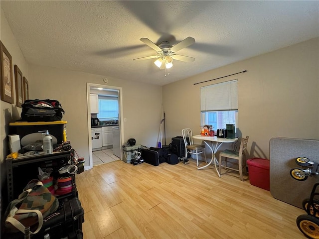1022-1024 S Trenton Ave, Regent Square, PA 15221 - misc room with separate washer and dryer, light wood finished floors, ceiling fan, plenty of natural light, and a textured ceiling