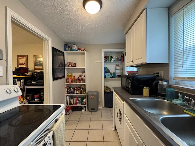 1022-1024 S Trenton Ave, Regent Square, PA 15221 - kitchen featuring white stove, black microwave, a sink, dark countertops, and white cabinetry