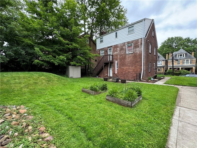 1022-1024 S Trenton Ave, Regent Square, PA 15221 - view of property exterior featuring a garden, brick siding, stairs, and a yard
