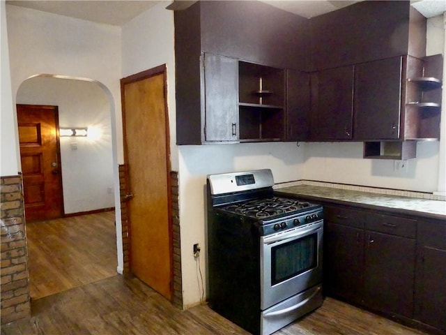 1112 Wade St, Aliquippa, PA 15001 - kitchen with stainless steel range with gas stovetop, open shelves, arched walkways, and dark wood finished floors