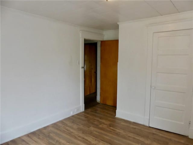 1112 Wade St, Aliquippa, PA 15001 - unfurnished bedroom with wood finished floors, ornamental molding, and baseboards